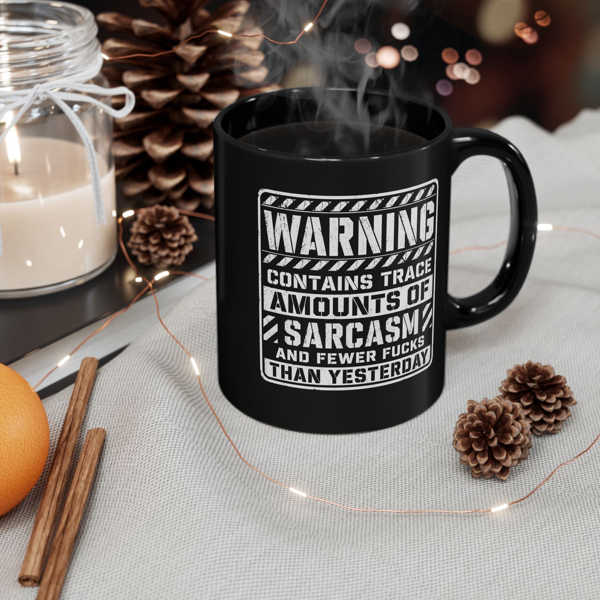 Black ceramic coffee mug printed with the warning label "Contains Trace Amounts of Sarcasm."