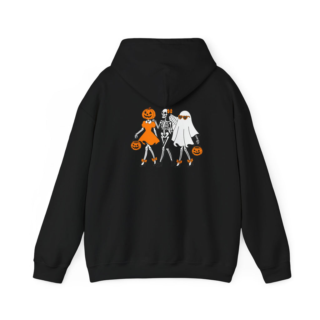 A black pullover hoodie shown from the back, featuring a graphic print of three Halloween characters: a pumpkin-headed figure in an orange dress, a skeleton in white, and a ghost figure with a white sheet, all holding orange pumpkins against a plain white background.