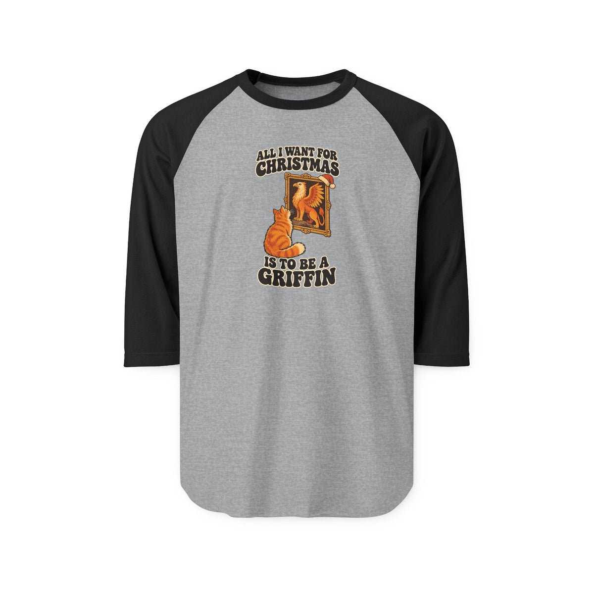 A 3/4 sleeve raglan baseball t-shirt with a heather gray body and black sleeves, featuring a Christmas-themed graphic on the chest of an orange griffin and the text 'ALL I WANT FOR CHRISTMAS IS TO BE A GRIFFIN
