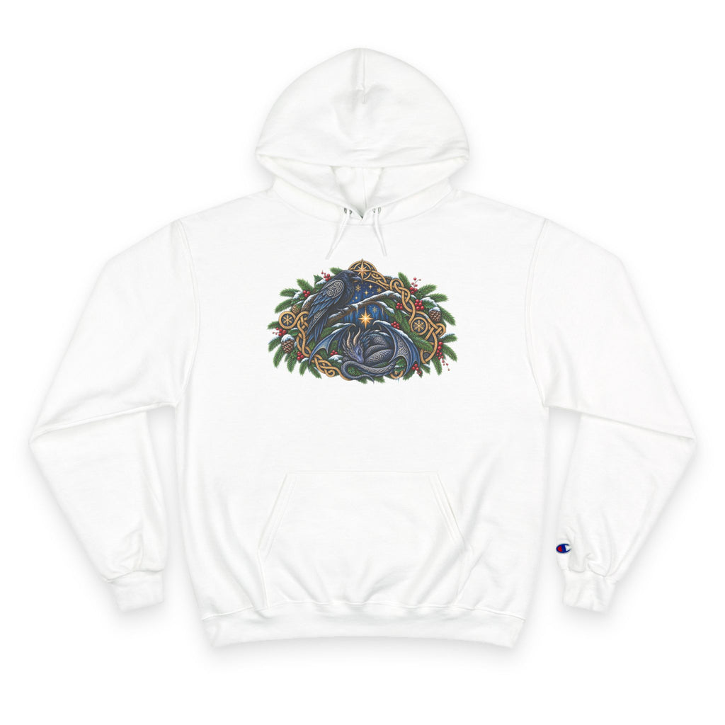 A white pullover hoodie featuring a detailed graphic of a blue raven and a dragon surrounded by green pine boughs  A small blue Champion 'C' logo is visible on the left sleeve cuff. against a white background