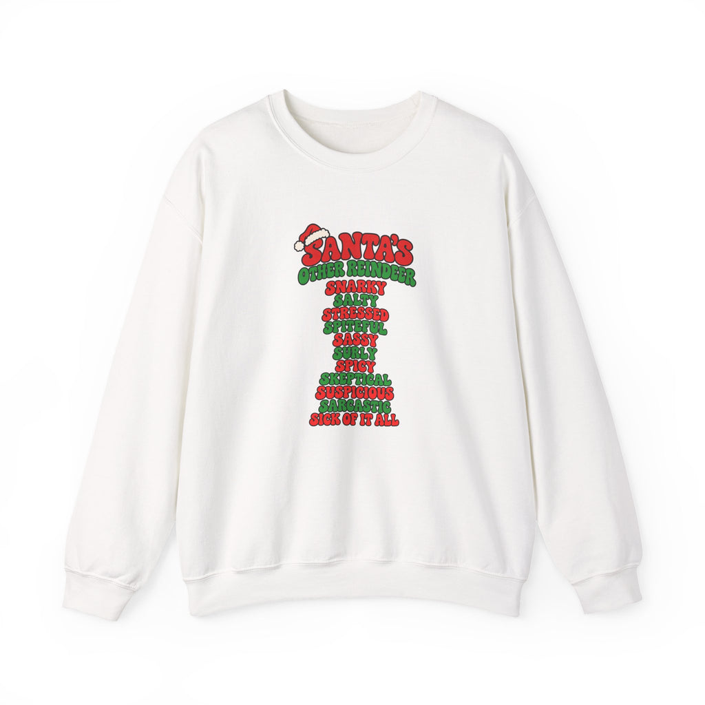 An off-white crewneck sweatshirt featuring a colorful graphic print on the front with the text 'SANTA'S OTHER REINDEER' in red and green, followed by a list of holiday reindeer names