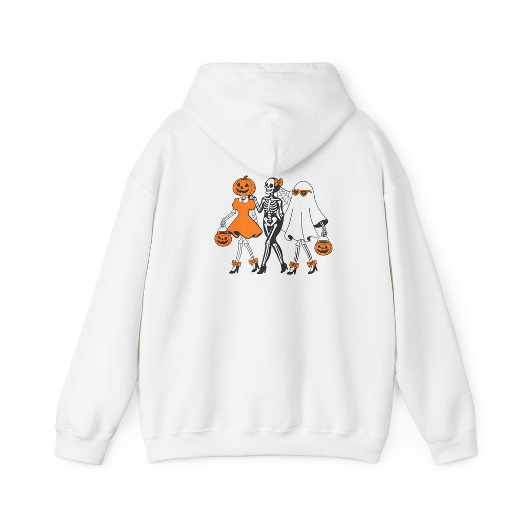 A white pullover hoodie shown from the back, featuring a graphic print of three cartoon Halloween characters: a pumpkin-headed girl in an orange dress, a skeleton in a black-and-white outfit, and a ghost in a white costume, all holding orange pumpkins.