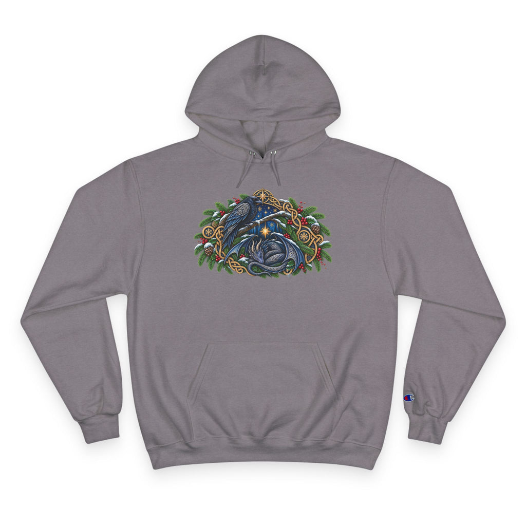 A gray pullover hoodie featuring a detailed graphic of a blue raven and a dragon surrounded by green pine boughs  A small blue Champion 'C' logo is visible on the left sleeve cuff. against a white background