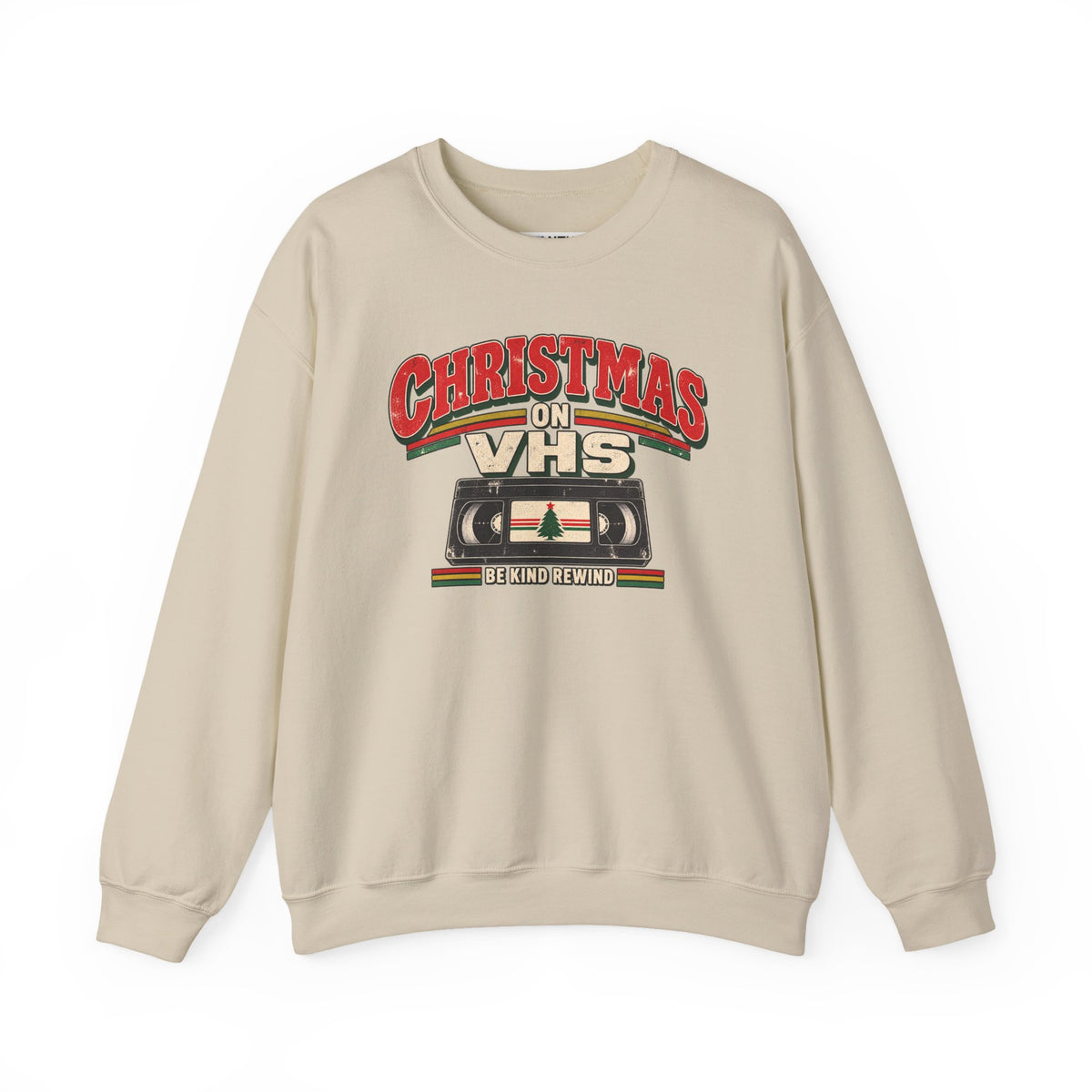 A beige crewneck sweatshirt featuring a retro VHS graphic with the text 'CHRISTMAS ON VHS' and 'BE KIND REWING' on a white background.