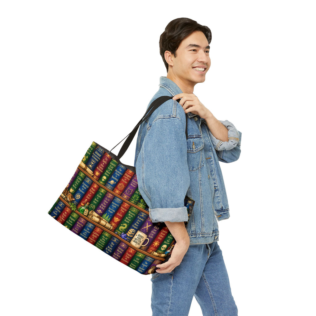 A man wearing a denim jacket and jeans carries a large tote bag over his shoulder. The tote bag features a colorful book spine pattern with gold lettering and a gold clasp, set against a plain white background.