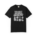 A black short-sleeve crewneck t-shirt featuring a white hand-drawn graphic that reads 'Sacred Geometry' crossed out above 'Scared Geometry' in bold lettering, with spooky-faced dice and geometric shapes below, shown on a plain white background.