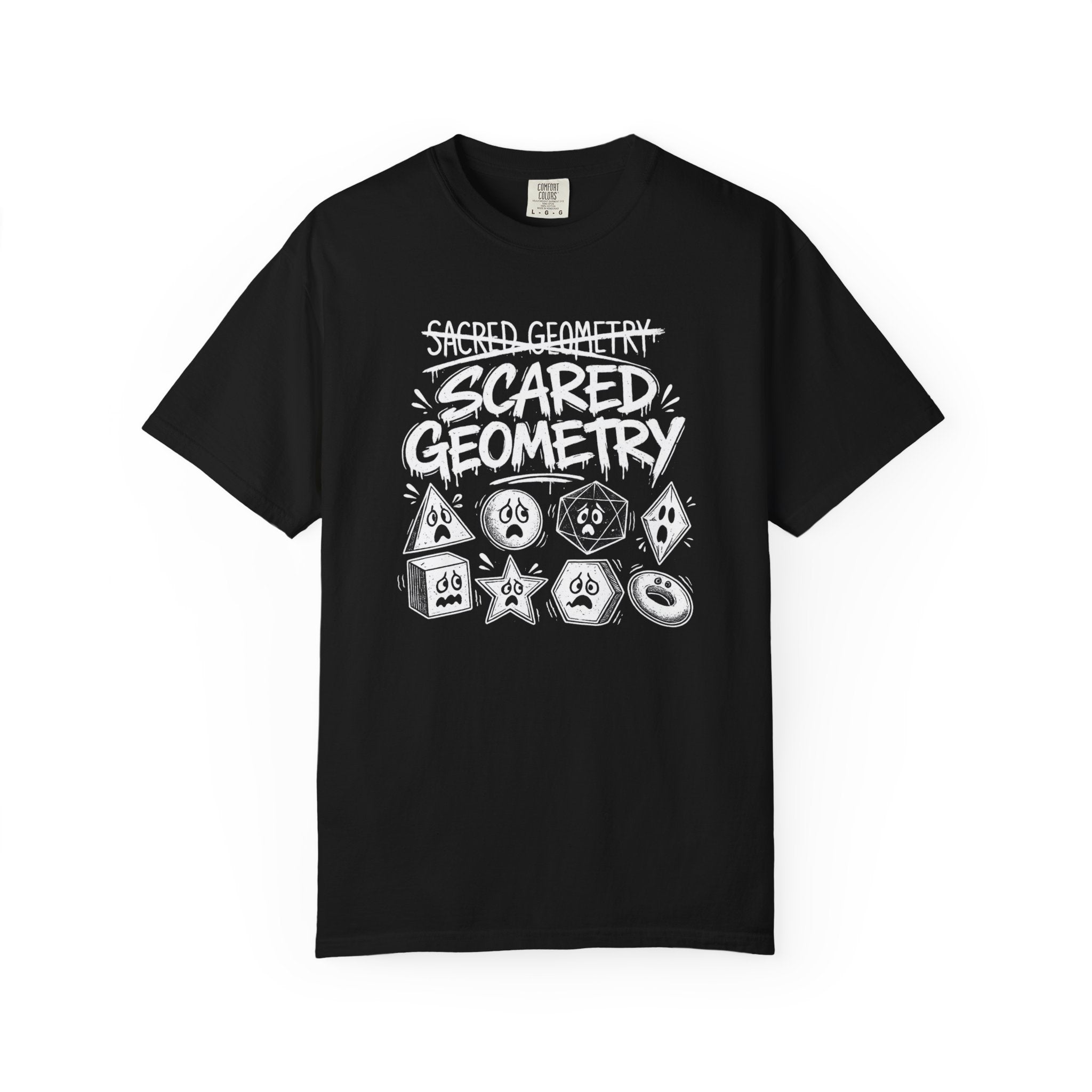 A black short-sleeve crewneck t-shirt featuring a white hand-drawn graphic that reads 'Sacred Geometry' crossed out above 'Scared Geometry' in bold lettering, with spooky-faced dice and geometric shapes below, shown on a plain white background.