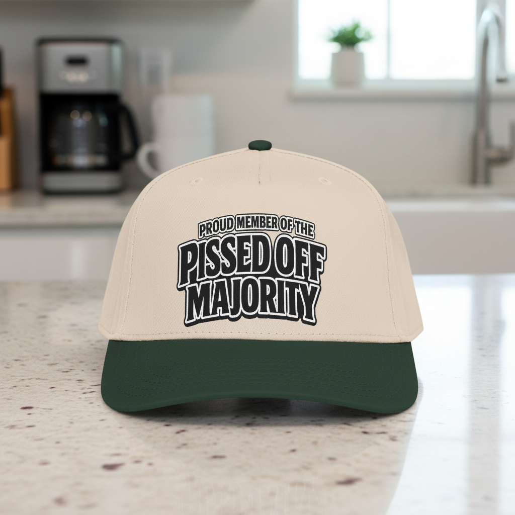 A two-tone baseball cap with a beige crown and a dark green visor, featuring the text 'PROUD MEMBER OF THE PISSED OFF MAJORITY' printed in black and white on the front.