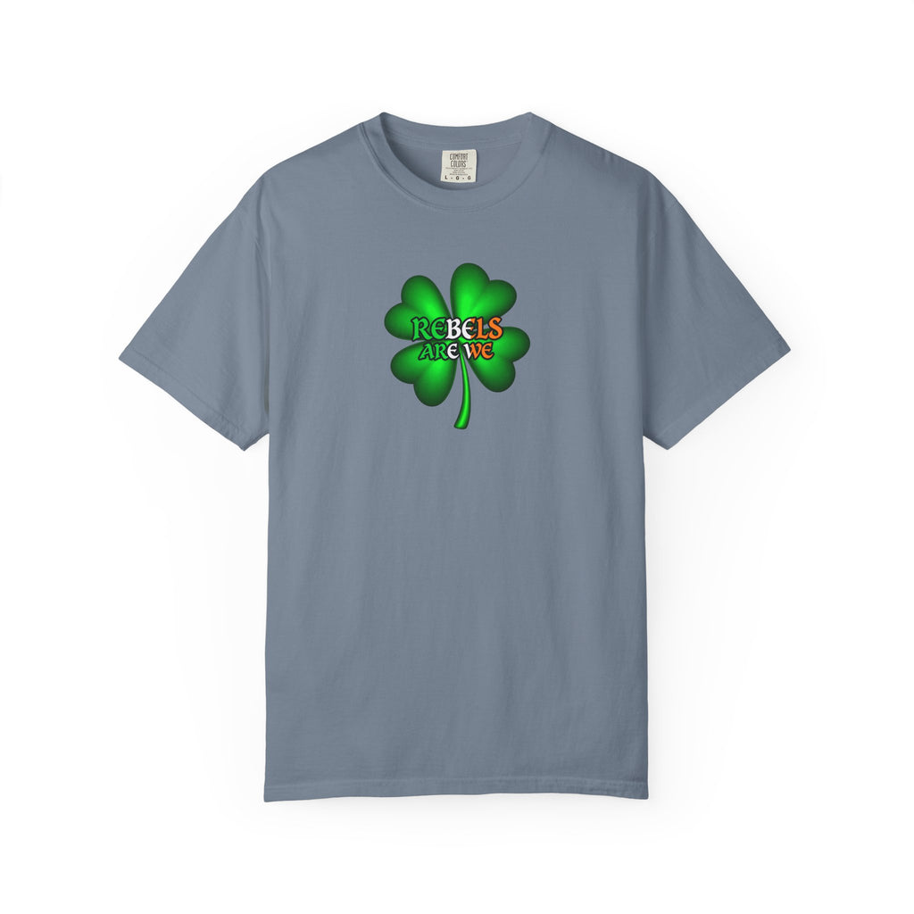 a slate blue short-sleeve crewneck t-shirt featuring a green four-leaf clover graphic on the chest with the text 'REBELS ARE WE' in red, orange, and yellow.