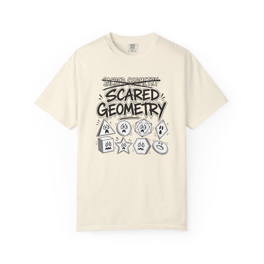 An off-white short-sleeve t-shirt with a black and gray graphic print on the front that reads 'SCARED GEOMETRY' above and below a collection of cartoonish gaming dice.
