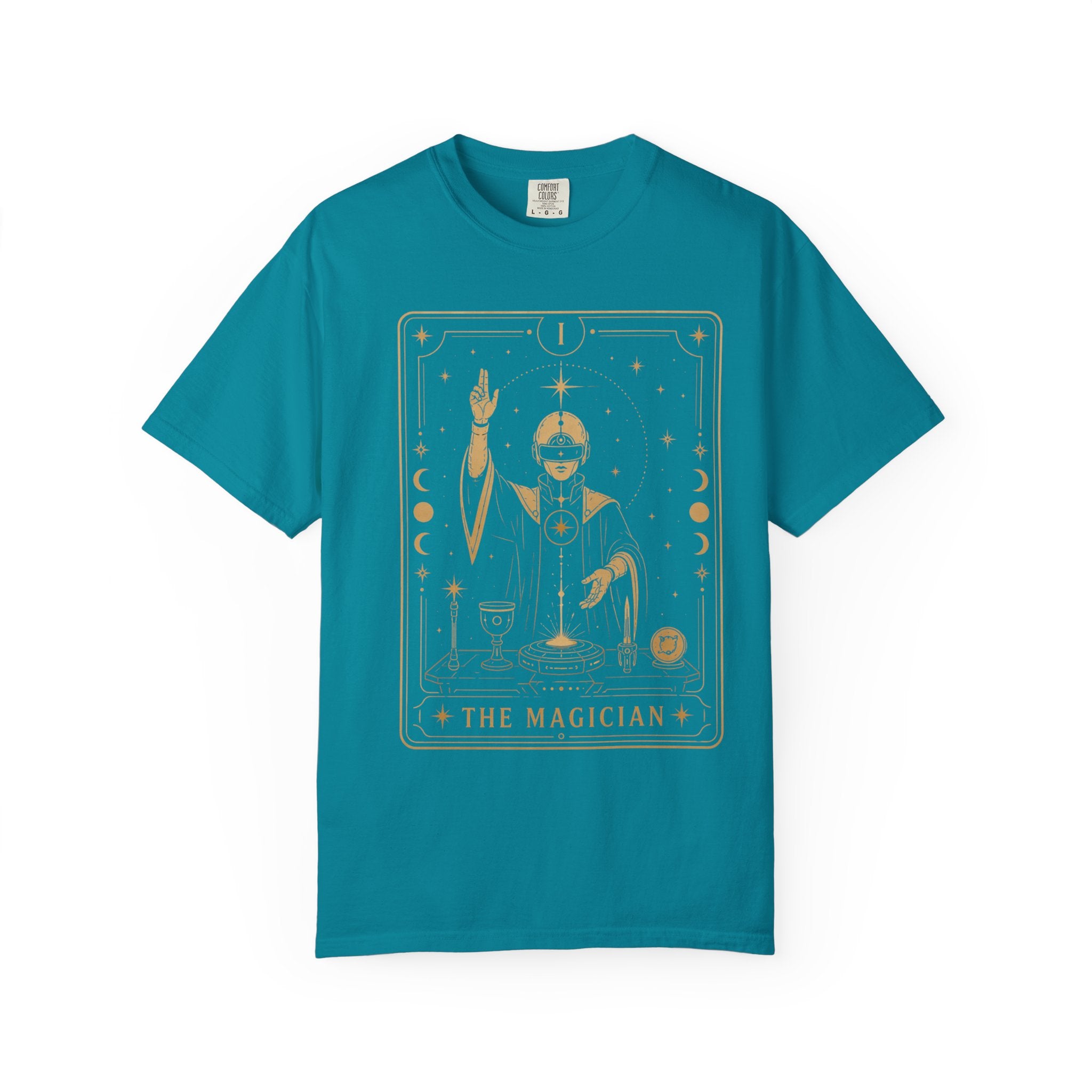 a teal blue crew neck t-shirt featuring The Magician from the Future Arcana collection, inspired by The Magician tarot card. A futuristic cosmic mystic channels radiant energy above a celestial altar within an elegant Art Deco frame rendered in vintage gold line art on a transparent background.