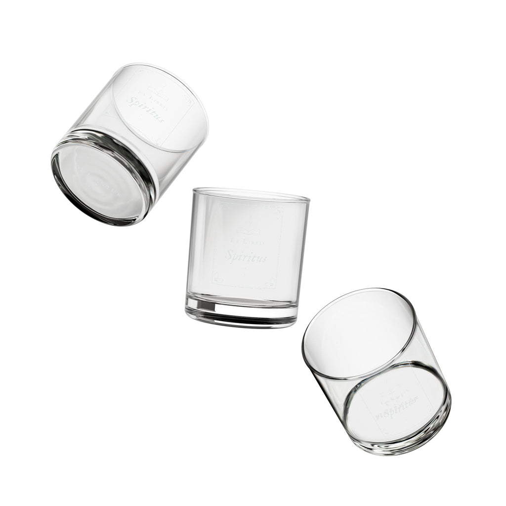 Set of three clear glass tumblers with gold geometric patterns on a white background