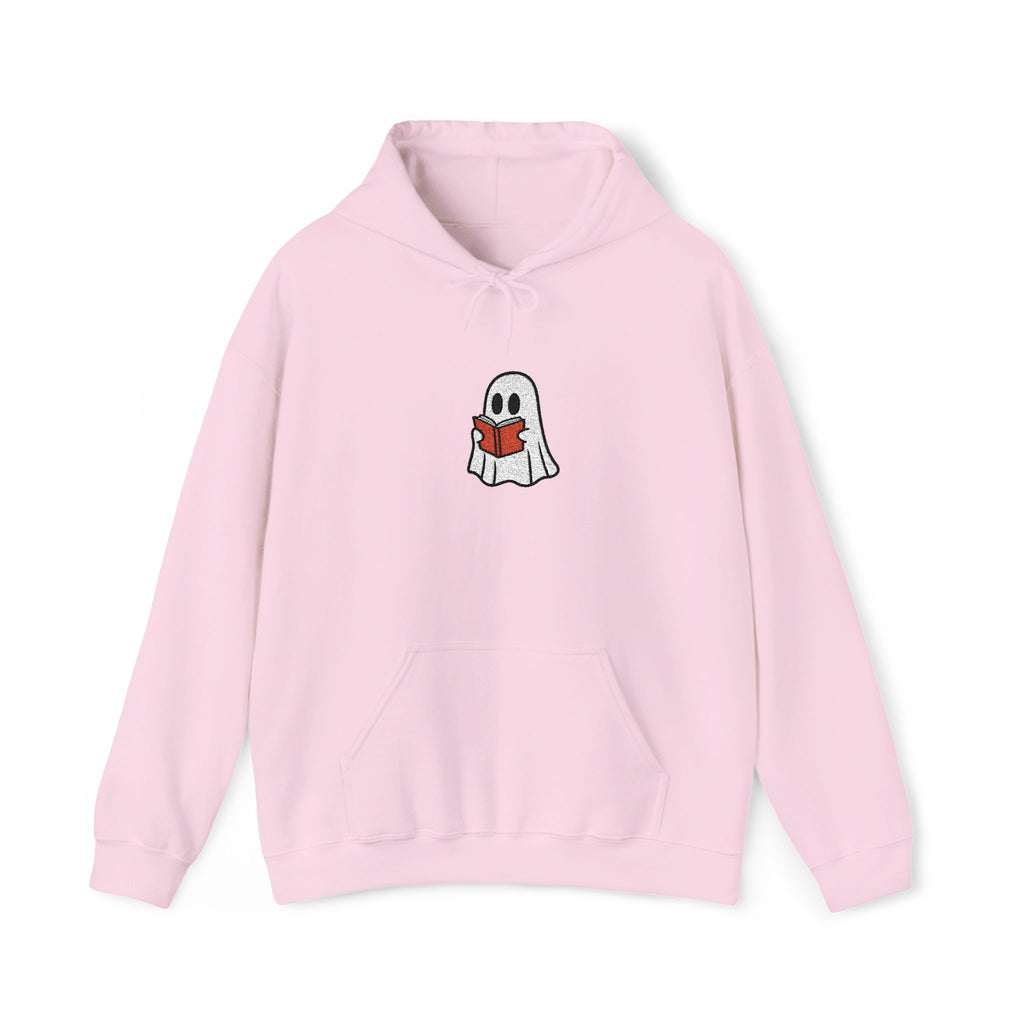 A light pink pullover hoodie featuring a small cartoon ghost graphic on the chest reading a red book, displayed against a clean white background.