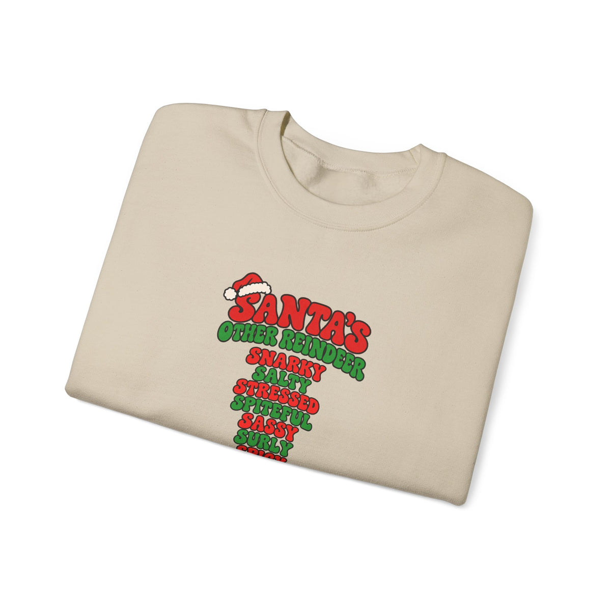 a folded beige crewneck sweatshirt featuring a red and green graphic print on the front that reads 'SANTA'S OTHER REiNDEER' followed by a list of humorous qualities in red and green text, shown against a plain white background.