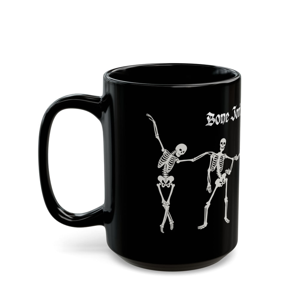 A black ceramic mug with white gothic-style text reading 'Bone Jovi' and a white skeleton dancing skeletons against a white background