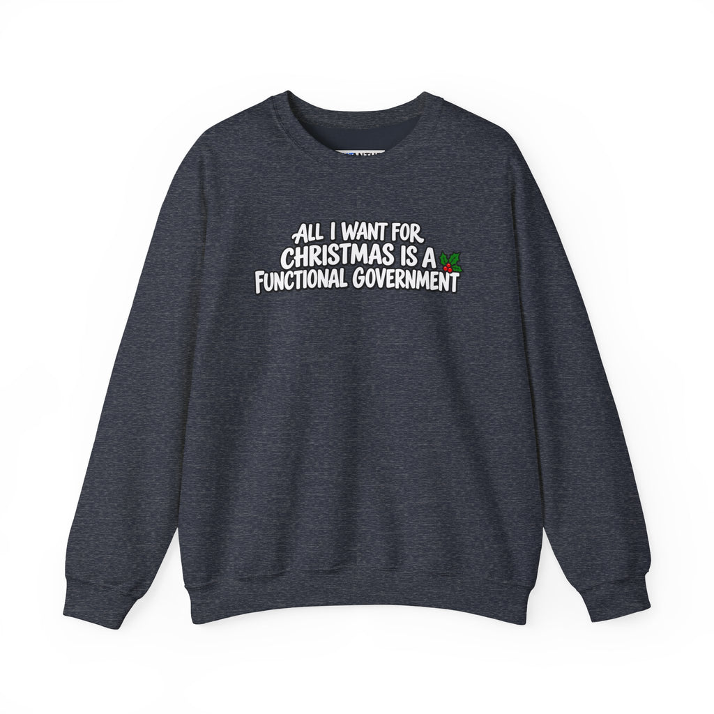 A dark heather gray crewneck sweatshirt with the text 'ALL I WANT FOR CHRISTMAS IS A FUNCTIONAL GOVERNMENT' printed in white across the chest, featuring a small green and red holiday accent.