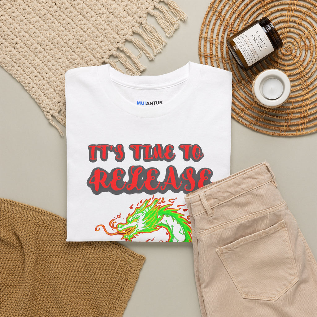 It's Time to Release the Dragon green fire dragon graphic t-shirt in white, folded flat lay styled with a knit blanket and jar