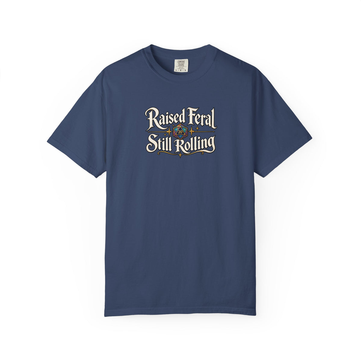 A blue graphic T-shirt  that features the text 'Raised Feral Still Rolling' with a colorful 20-sided die graphic in the center against a white background