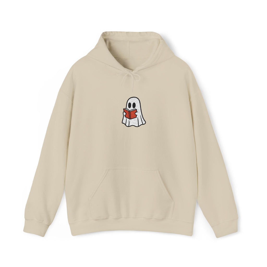 A beige hoodie with a cartoon ghost holding a red book against a white background