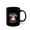 A black ceramic mug with a Halloween-themed graphic that reads 'DO NOT DISTURB RESPAWNING' in orange and white text, featuring a cartoon ghost holding a steaming cup and a progress bar, on a white background.