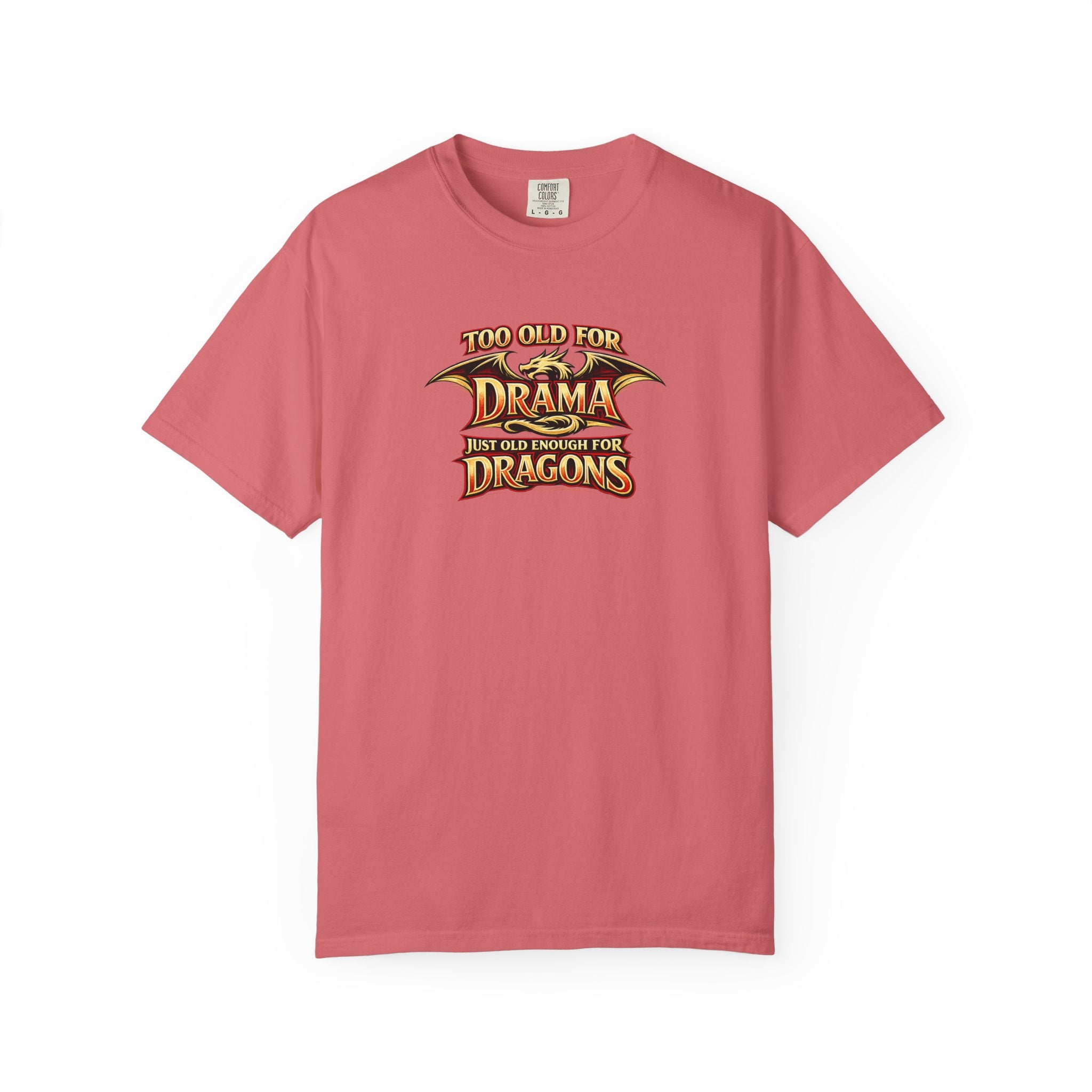 A pink short-sleeve crewneck t-shirt with a graphic on the chest that reads 'TOO OLD FOR DRAMA BUT OLD ENOUGH FOR DRAGONS' in a stylized gold and black dragon-themed font, displayed on a clean white background.