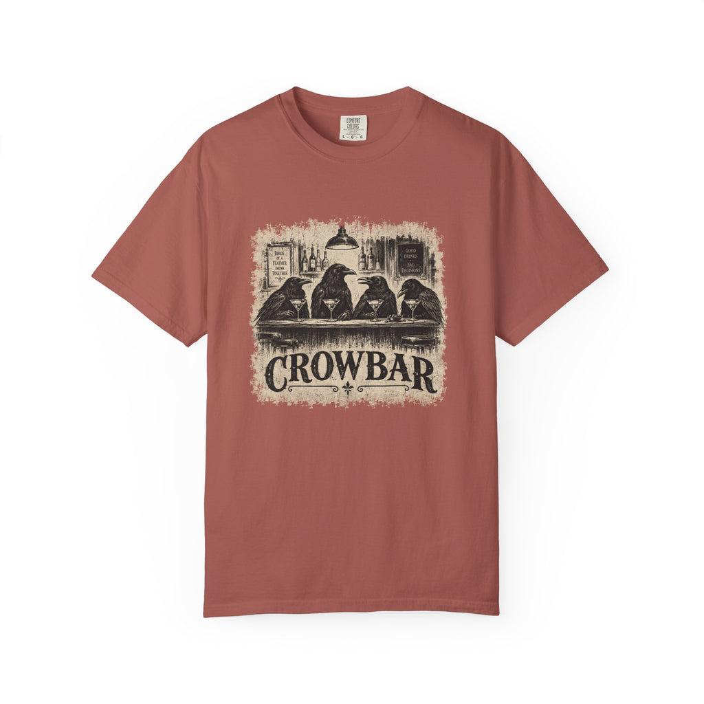 A dusty rose short-sleeve crewneck t-shirt featuring a vintage-style graphic print of four crows sitting at a bar with the text 'CROWBAR' underneath, displayed on a clean white background.
