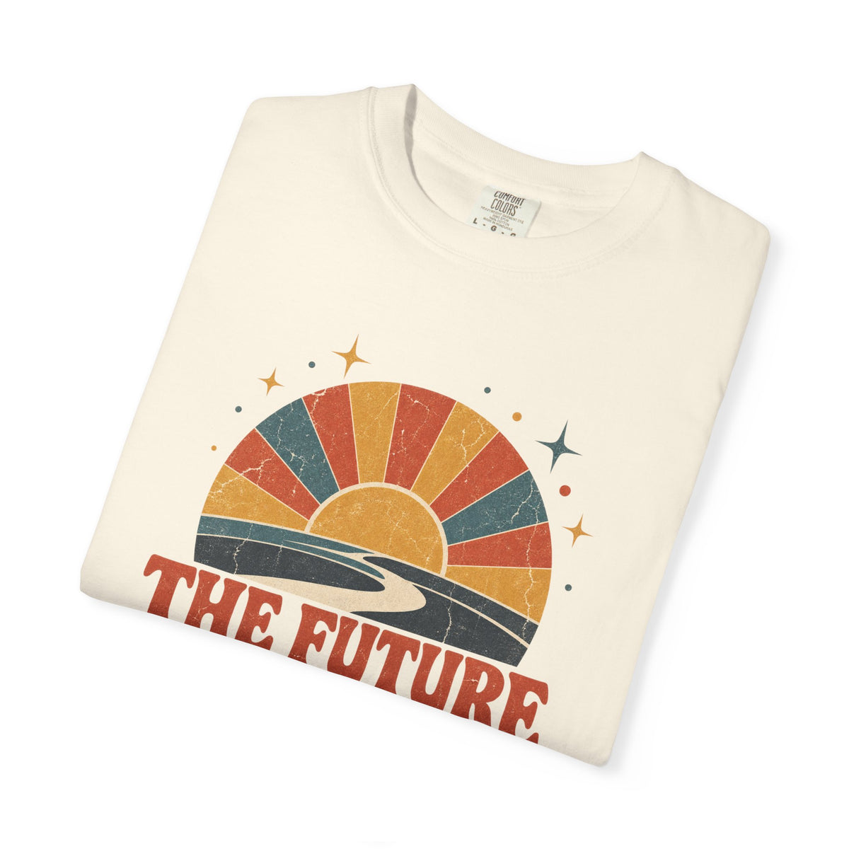 A folded cream-colored t-shirt with a retro sunset graphic and the text 'THE FUTURE' printed on the front, displayed on a clean white background.