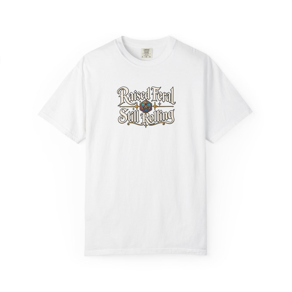 A white graphic T-shirt  that features the text 'Raised Feral Still Rolling' with a colorful 20-sided die graphic in the center against a white background