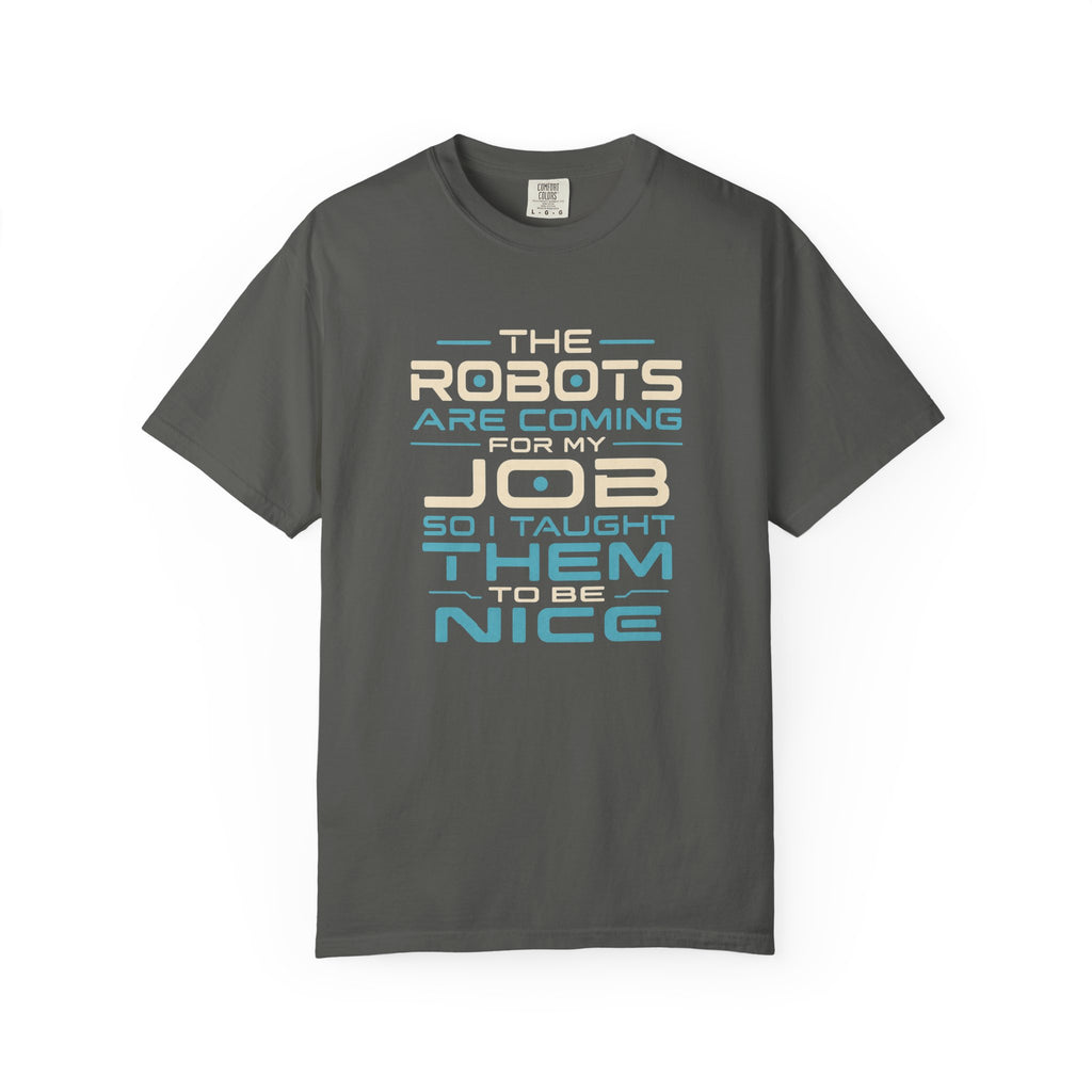 A dark gray short-sleeve t-shirt with a humorous text graphic on the front that reads 'THE ROBOTS ARE COMING FOR MY JOB SO I TAUGHT THEM TO BE NICE' in cream and light blue lettering, displayed on a clean white background.