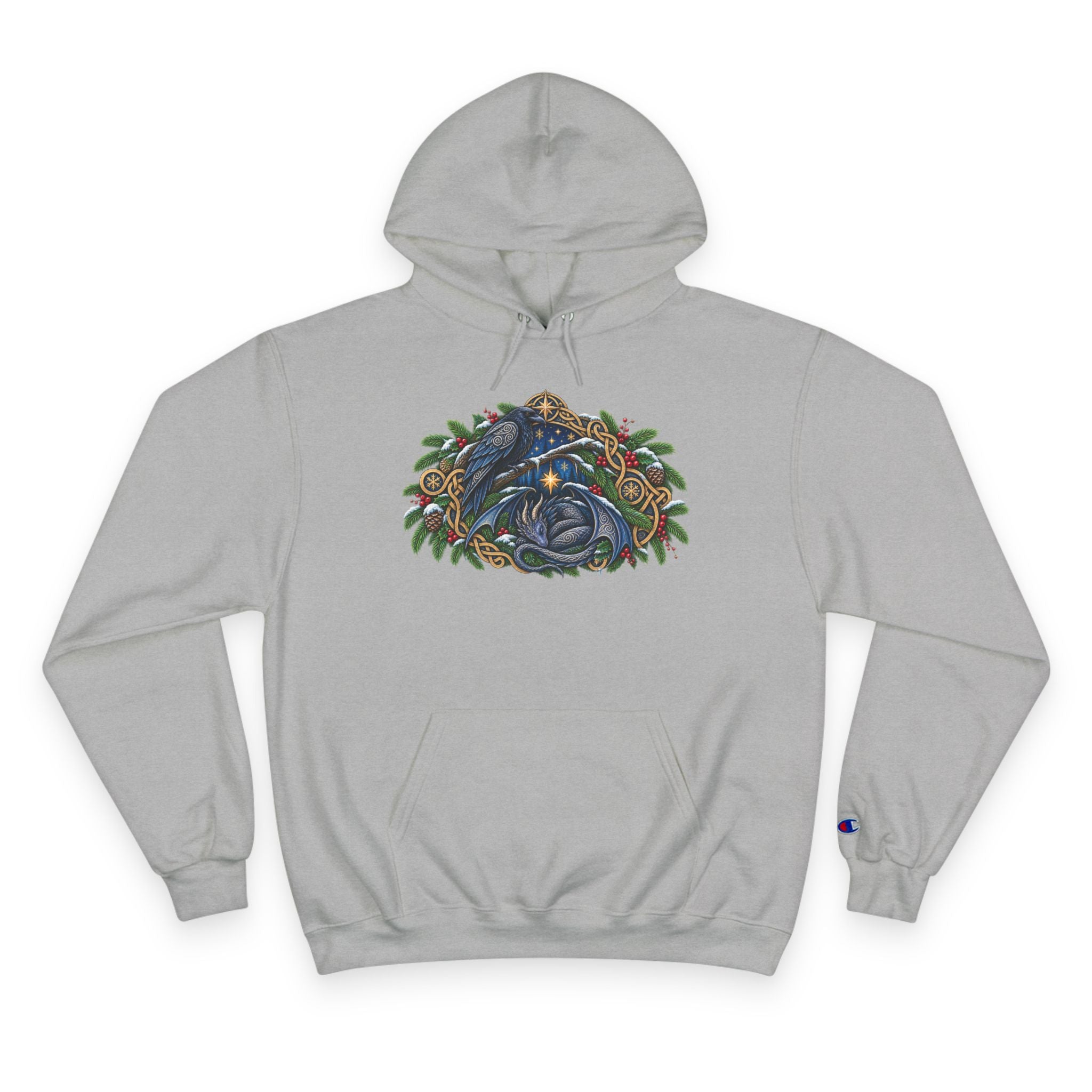 A light gray pullover hoodie featuring a detailed graphic of a blue raven and a dragon surrounded by green pine boughs  A small blue Champion 'C' logo is visible on the left sleeve cuff. against a white background