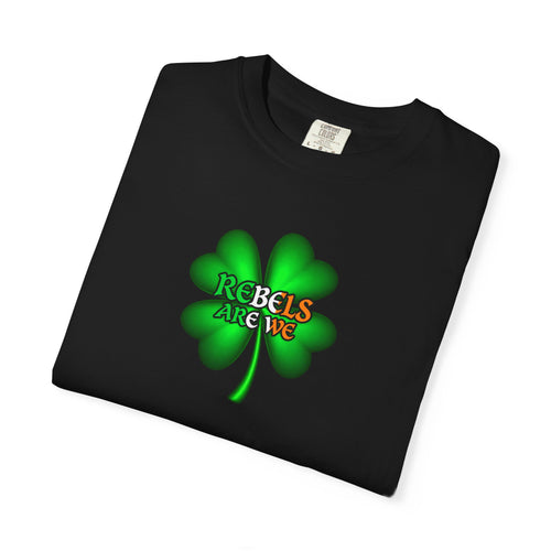 a black folded shirt  featuring a green four-leaf clover graphic on the chest with the text 'REBELS ARE WE' in red, yellow, and green.