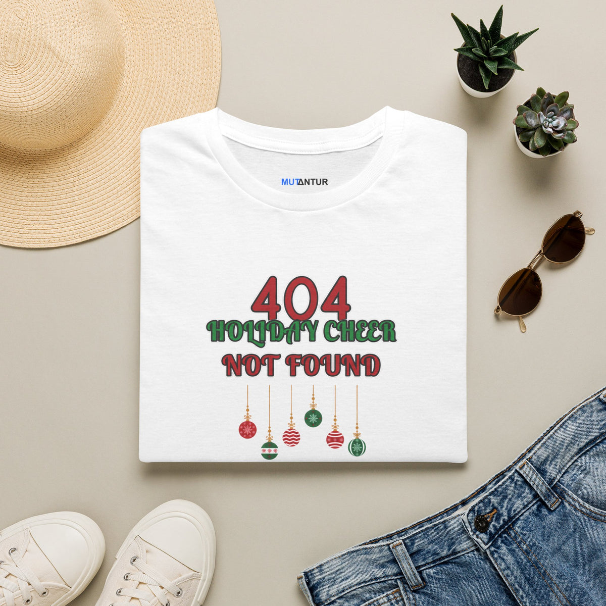 A folded white crewneck t-shirt with a holiday-themed graphic on the chest that reads '404 HOLIDAY CHEER NOT FOUND' in red and dark green text with hanging ornaments.