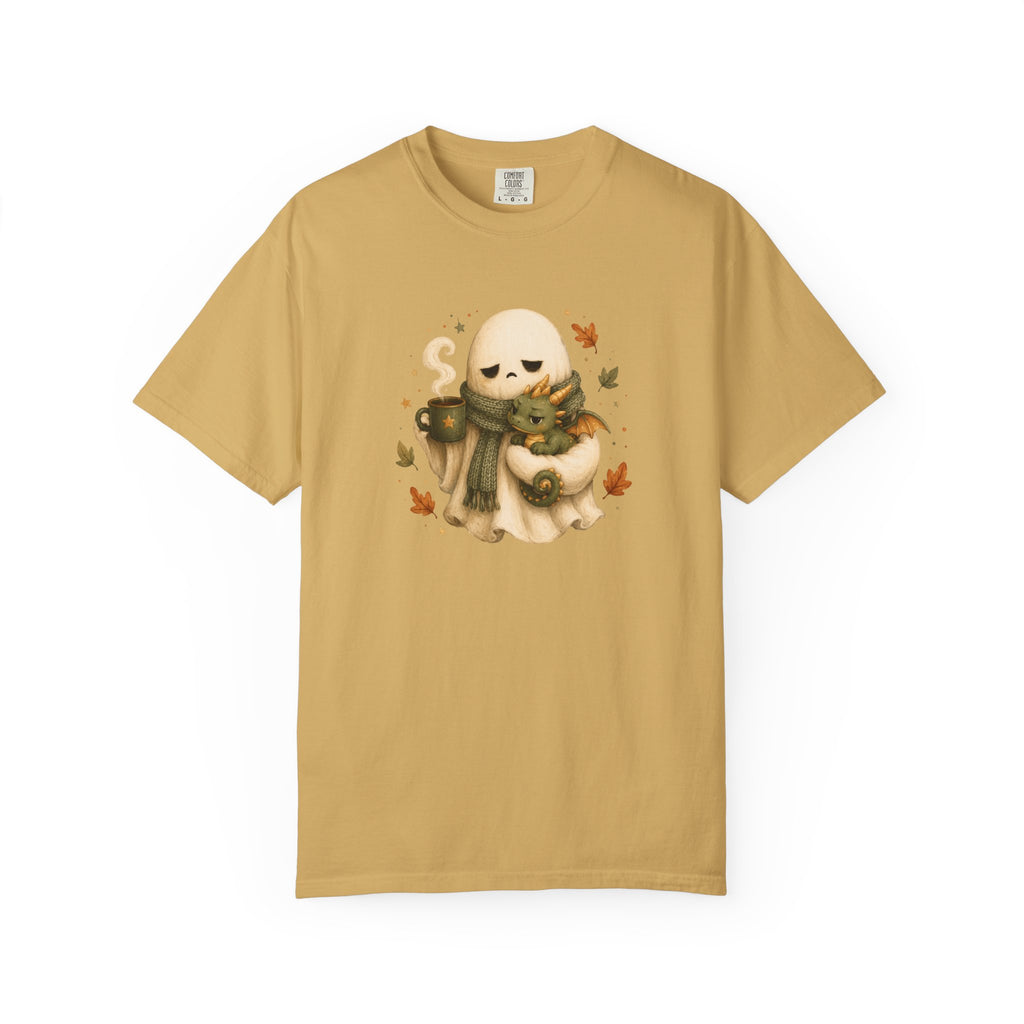 A mustard  short-sleeve crewneck t-shirt featuring a central graphic of a cute cream-colored ghost wearing a green scarf and holding a small dragon, surrounded by autumn leaves 