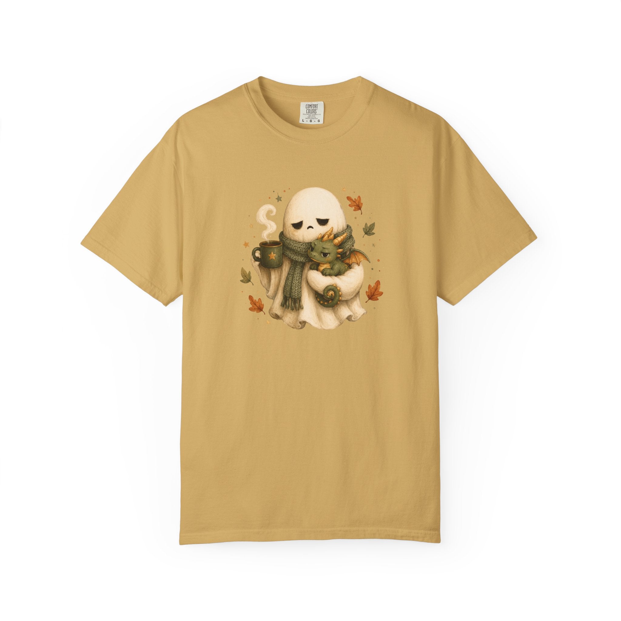 A mustard  short-sleeve crewneck t-shirt featuring a central graphic of a cute cream-colored ghost wearing a green scarf and holding a small dragon, surrounded by autumn leaves 