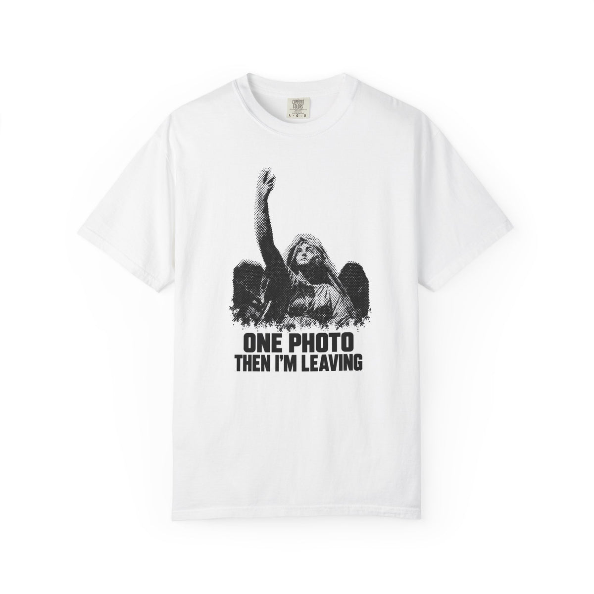 A white short-sleeve crewneck t-shirt featuring a black graphic print of a woman with a raised hand and the text 'ONE PHOTO THEN I'M LEAVING' underneath.
