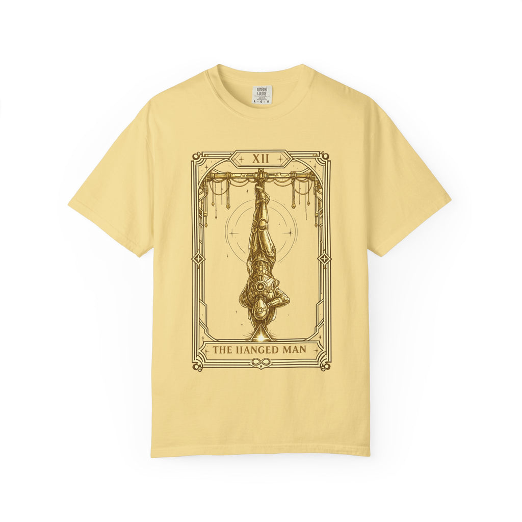 A pale yellow short-sleeve t-shirt with a dark brown tarot card graphic of 'The Hanged Man' on the front, displayed against a solid white background.