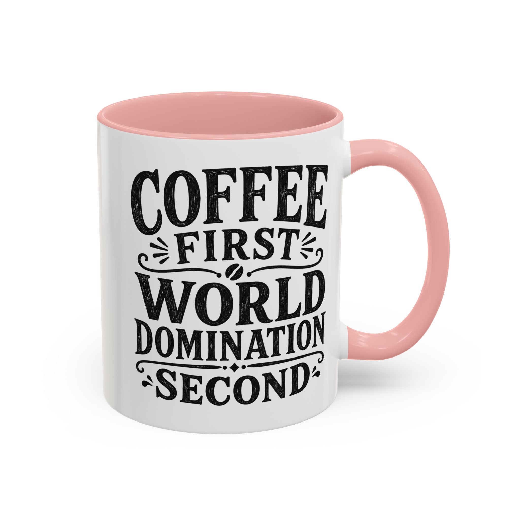 A white ceramic coffee mug with a pink interior and handle, featuring the text 'COFFEE FIRST WORLD DOMINATION SECOND' in black lettering.