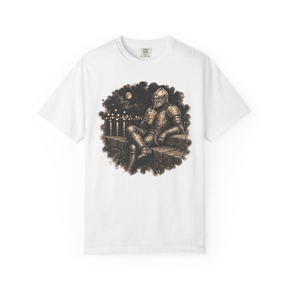 A white short-sleeve crewneck t-shirt featuring a circular graphic print of a knight in armor sitting on a stone wall under a full moon, drinking iced coffee