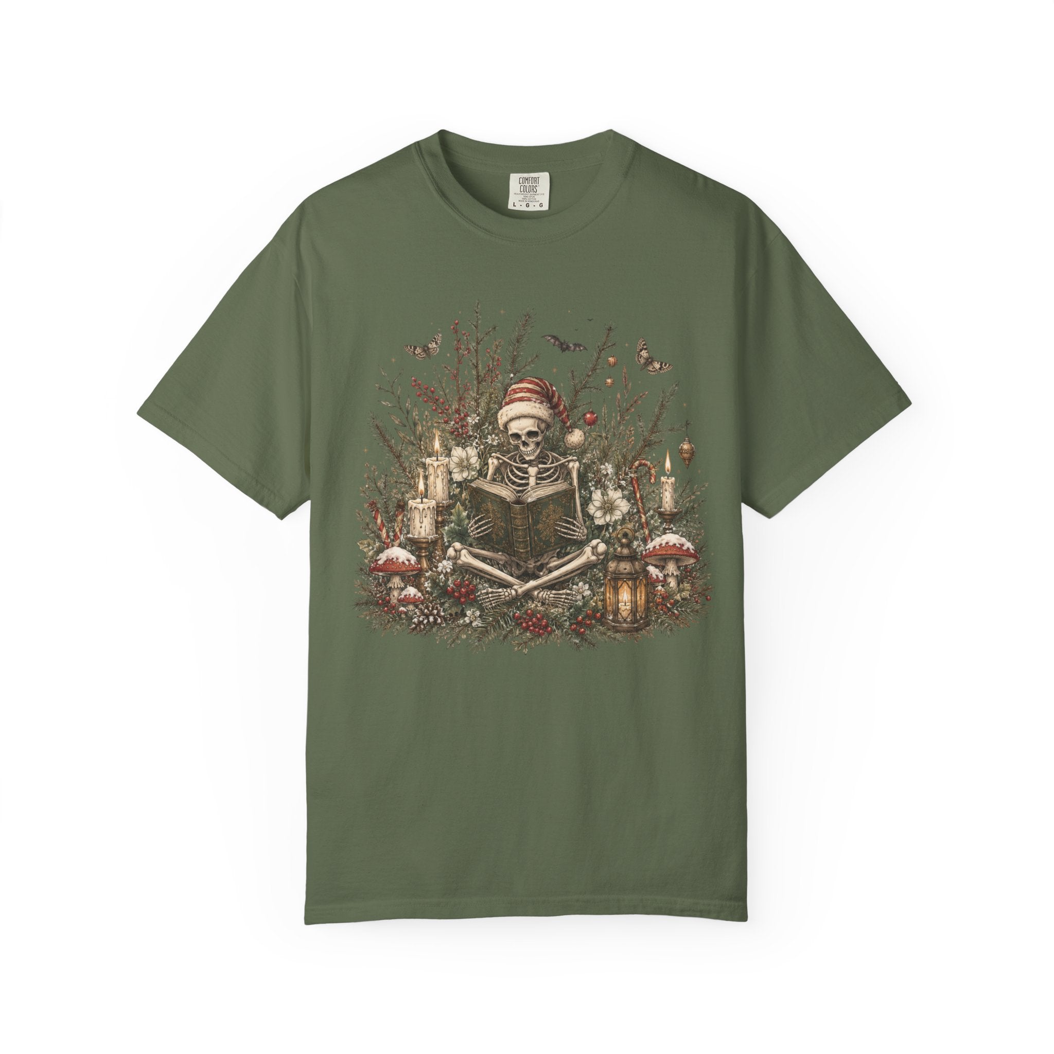 A green short-sleeve crewneck t-shirt featuring a detailed graphic print of a skeleton wearing a Santa hat, surrounded by Christmas trees, candles, and mushrooms.