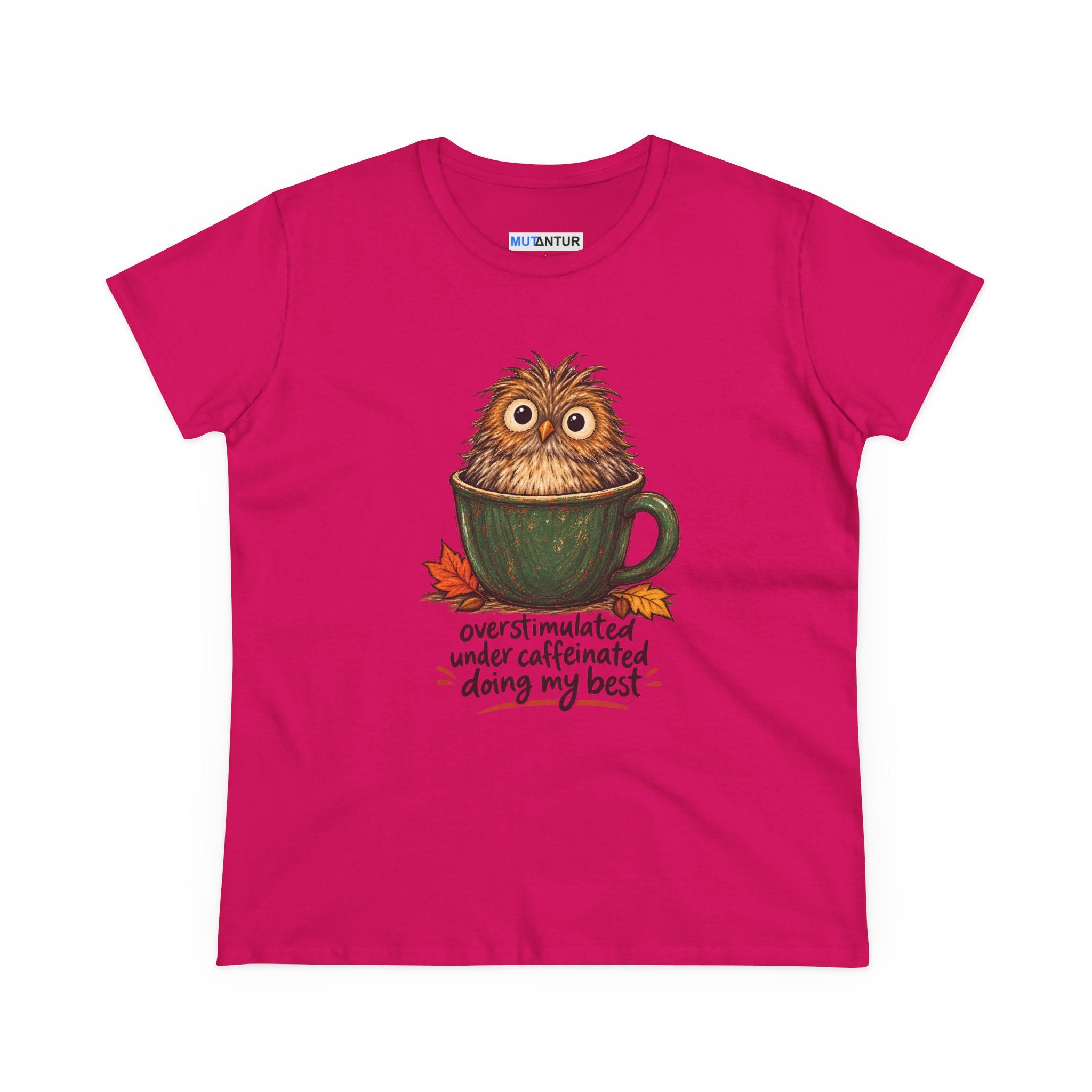 A bright pink short-sleeve t-shirt with a graphic of a cute owl sitting in a green mug, surrounded by autumn leaves and the text 'overstimulated under caffeinated doing my best'.