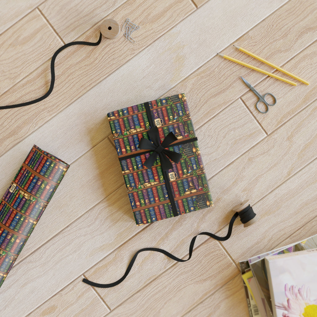 Two presents tied with a black ribbon on a wooden floor with scissors and pencils.