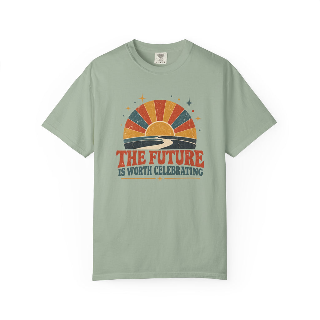 A sage green short-sleeve t-shirt with a retro sunset graphic and the text 'THE FUTURE IS WORTH CELEBRATING' printed on the chest, displayed against a plain white background.