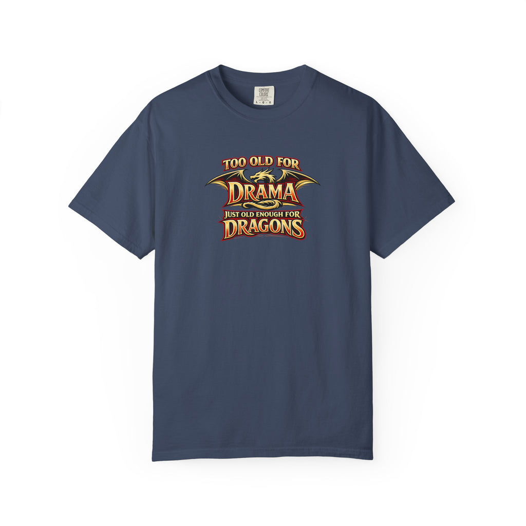 An blue short-sleeve crewneck t-shirt featuring a graphic print on the chest that reads 'TOO OLD FOR DRAMA BUT OLD ENOUGH FOR DRAGONS' in a stylized gold and black dragon-themed font.