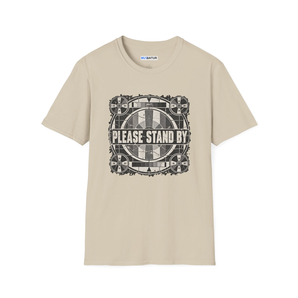 a beige crew neck t shirt with a retro black and white television display sign that reads  PLEASE STAND BY against a white background