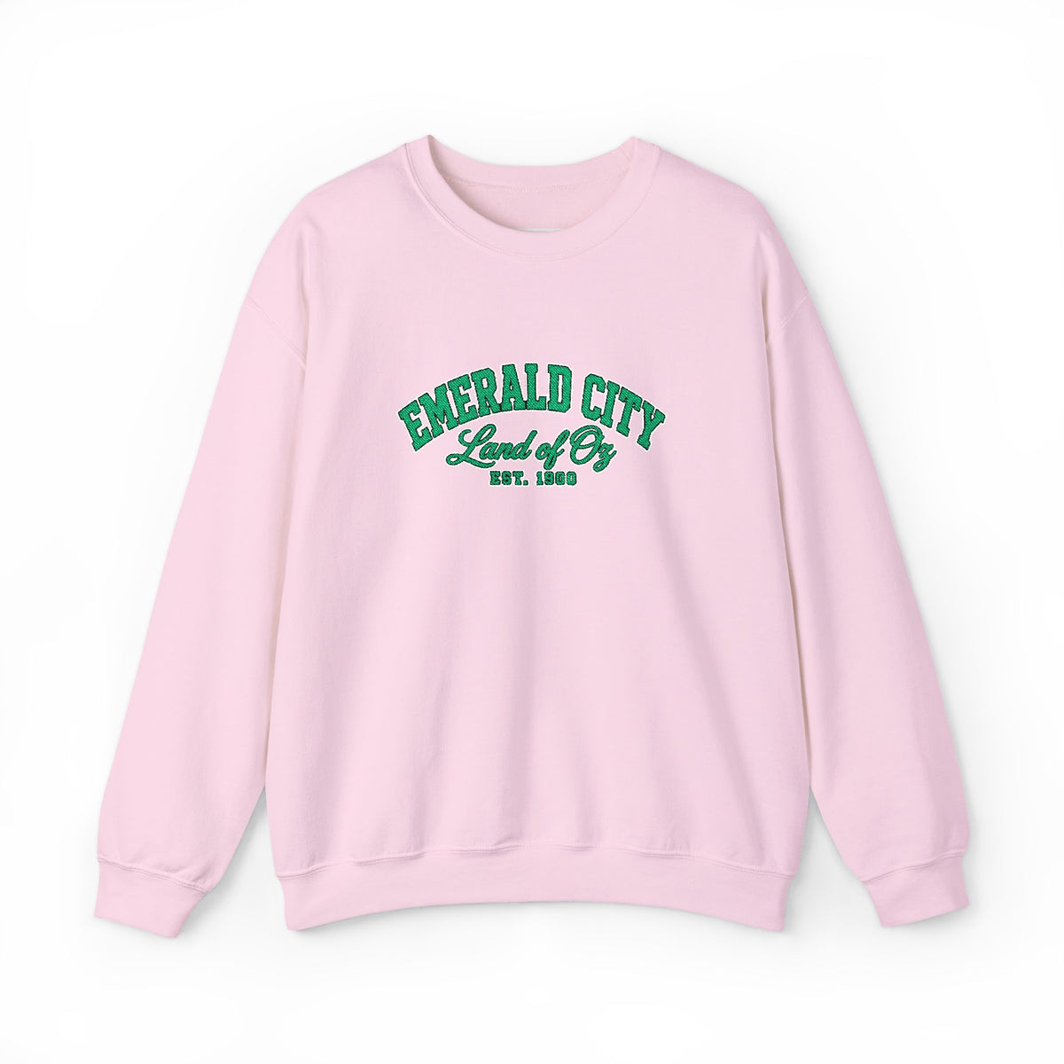 A light pink crewneck sweatshirt with 'EMERALD CITY Land of Oz EST. 1900' printed in green varsity-style lettering on the chest, displayed against a clean white background.