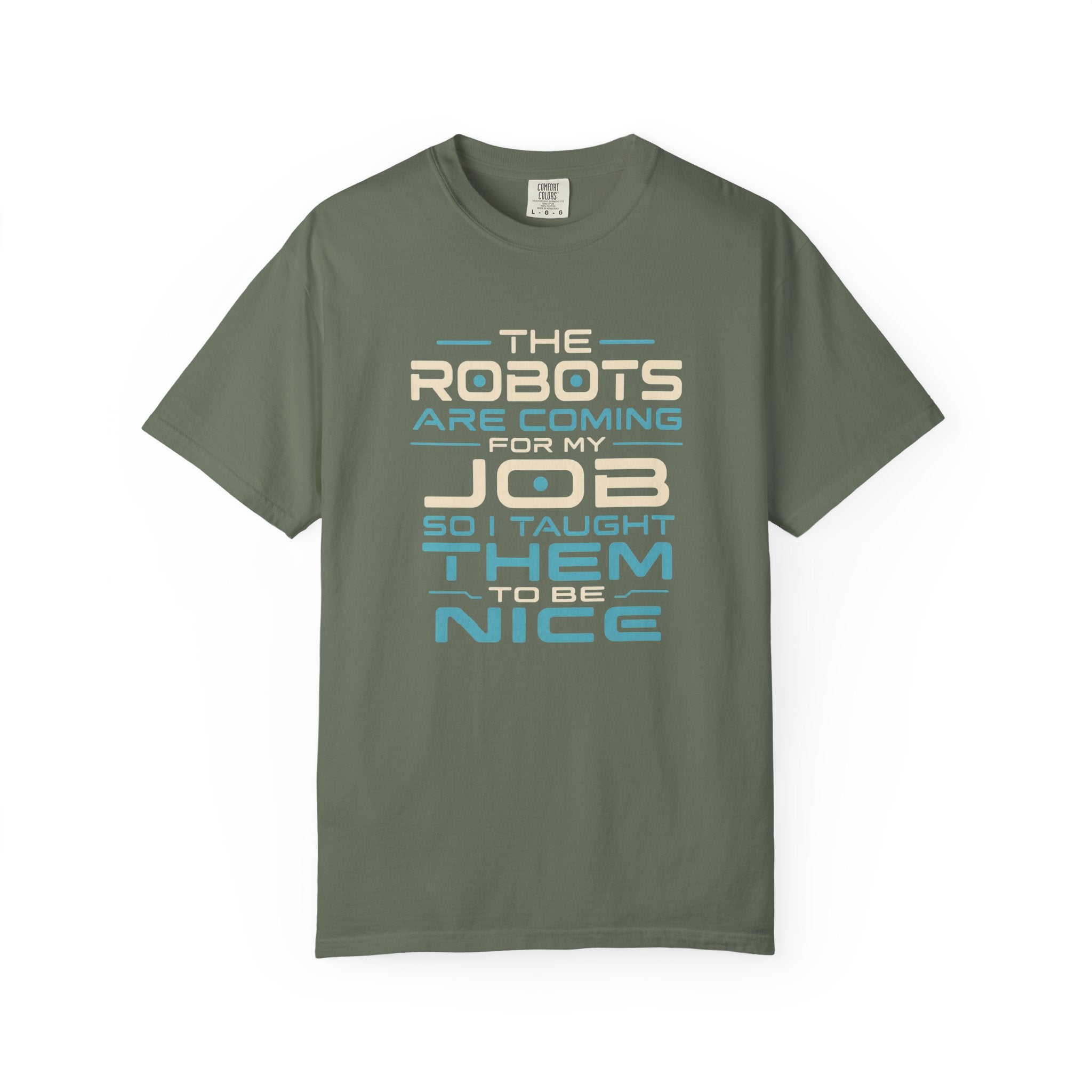 A khaki short-sleeve crewneck t-shirt with a retro-style text graphic on the chest that reads 'THE ROBOTS ARE COMING FOR MY JOB SO I TAUGHT THEM TO BE NICE' in beige and light blue lettering, displayed on a clean white background.