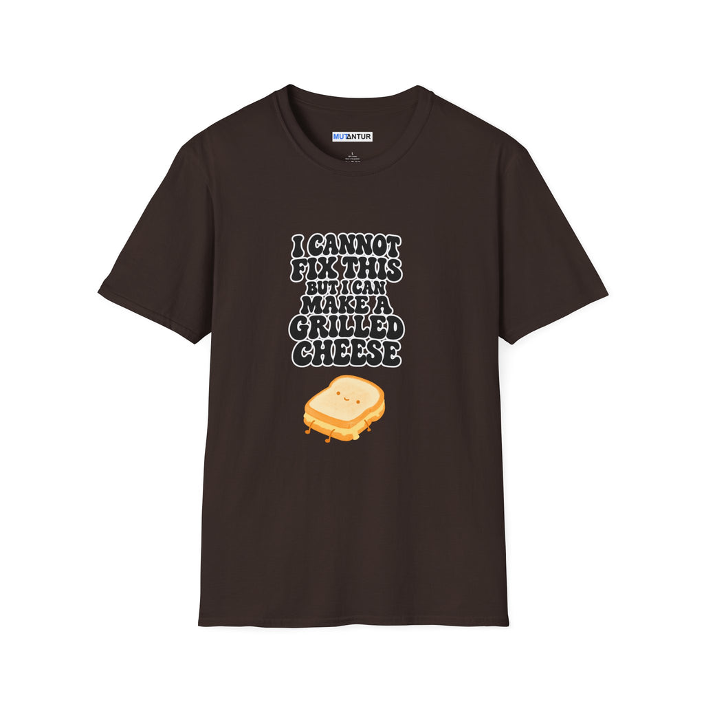 A dark brown short-sleeve t-shirt with a graphic on the front that reads 'I CANNOT FIX THIS BUT I CAN MAKE A GRILLED CHEESE' in a white and black bubbly font, above a cartoon grilled cheese sandwich. The shirt is displayed flat against a solid white background