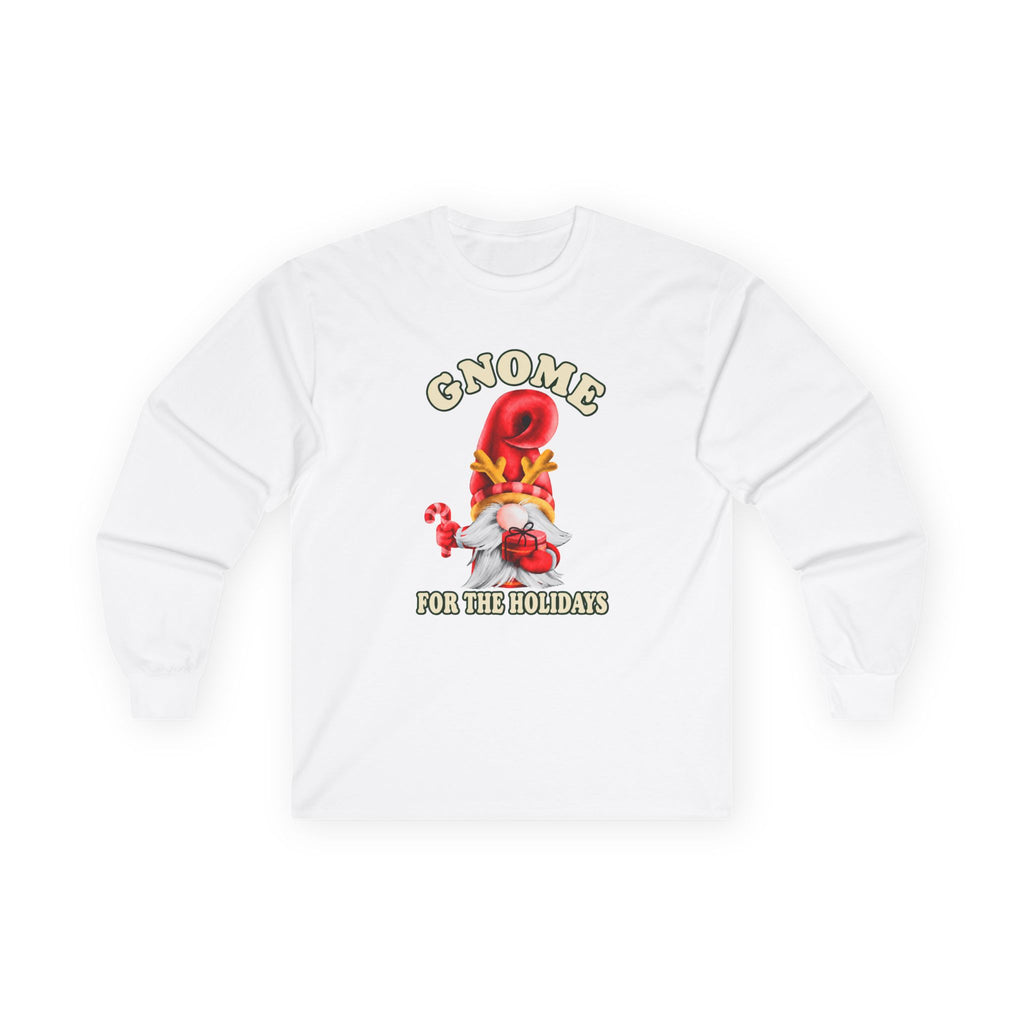 A white long-sleeve t-shirt with a festive gnome graphic on the chest. The graphic features a red gnome figure wearing a yellow hat, holding a small red gift box, with the text 'GNOME FOR THE HOLIDAYS' in a stylized font.