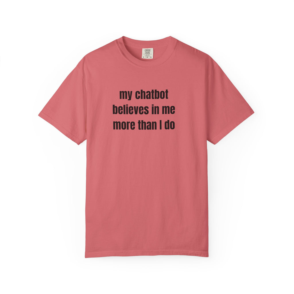 A watermelon short-sleeve crewneck t-shirt with the text 'my chatbot believes in me more than I do' printed in black sans-serif font across the chest, displayed on a clean white background.