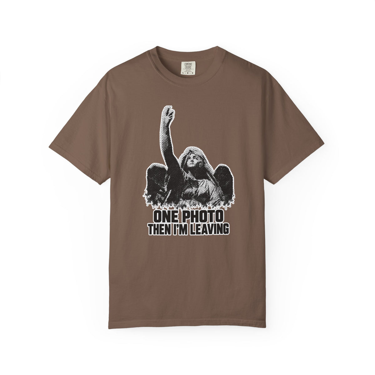A brown short-sleeve crewneck t-shirt with a black and white graphic of a winged angel raising its hand, above the text 'ONE PHOTO THEN I'M LEAVING'.